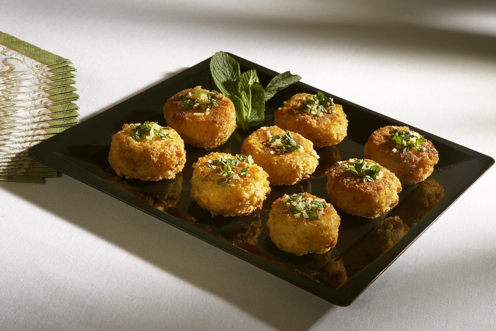 A tray of baked cheese and spinach muffins.