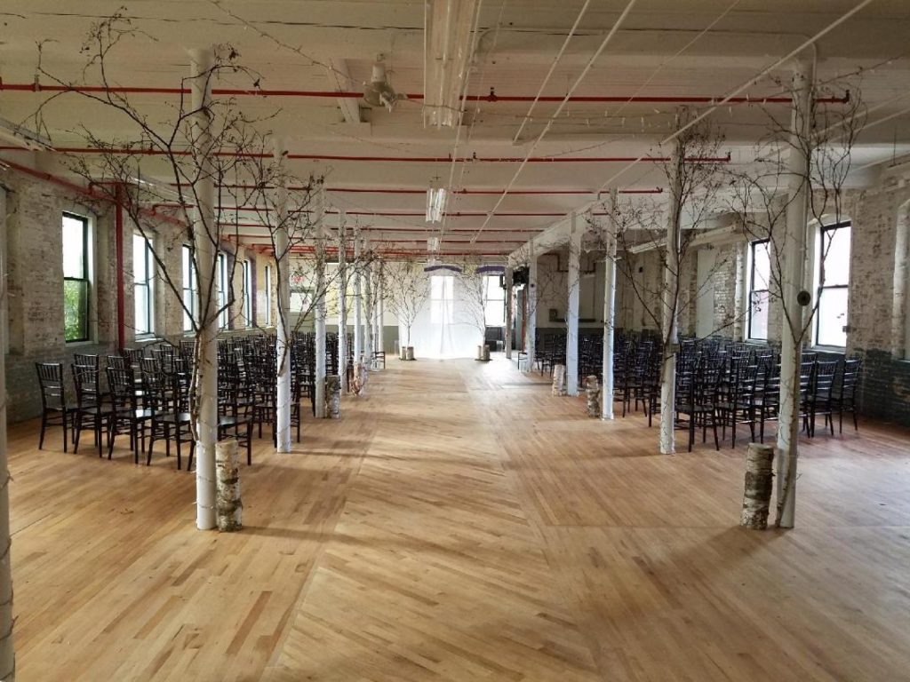 A large room with many chairs and trees