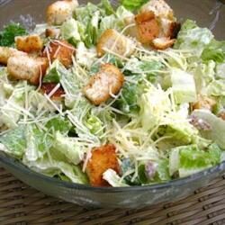 A salad with lettuce, croutons and cheese.